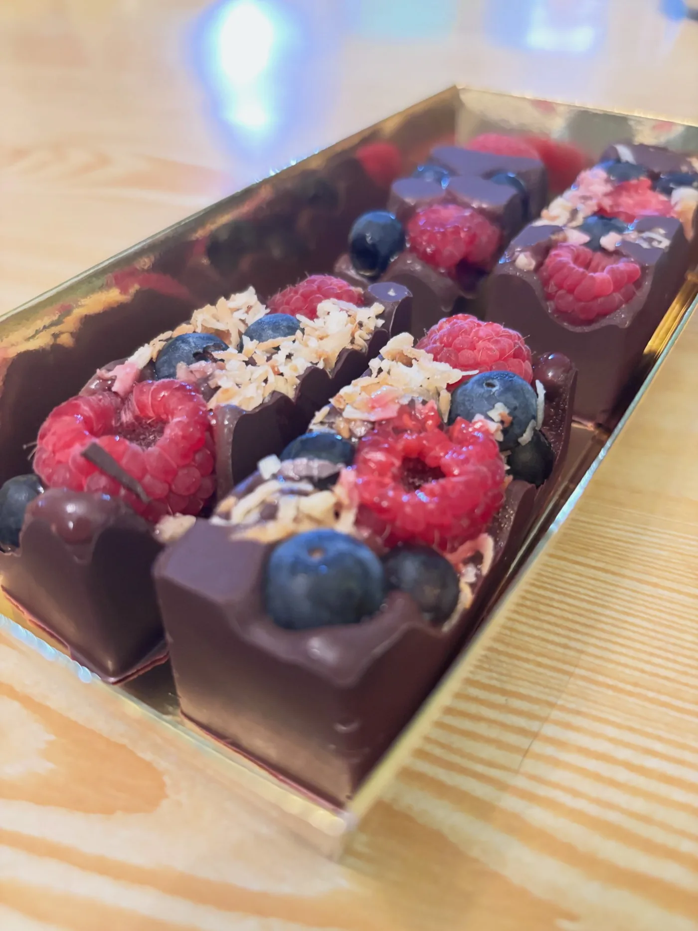 Handcrafted chocolate pieces with berries